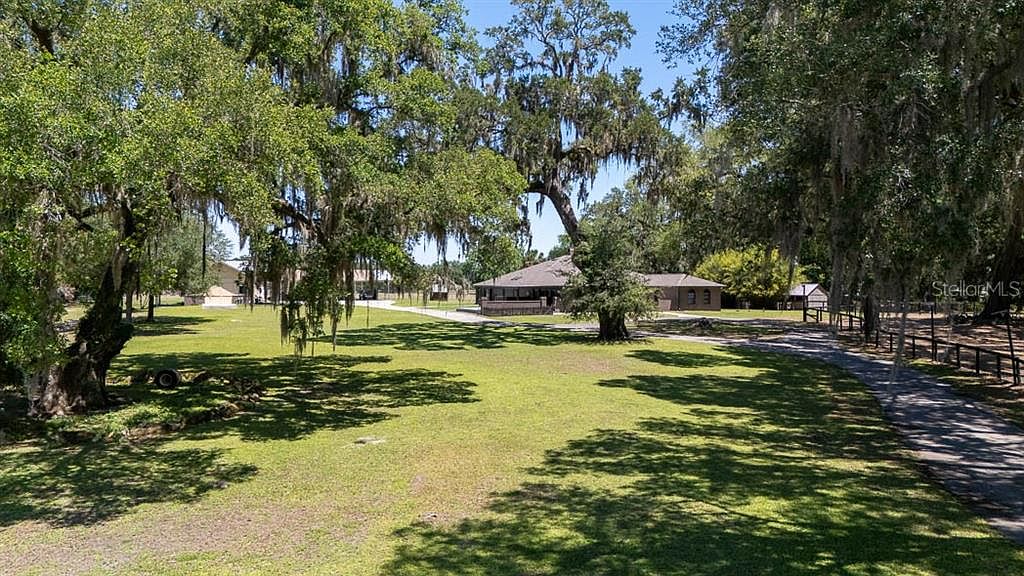 Driveway approach beneath grandfather oaks draped with Spanish moss